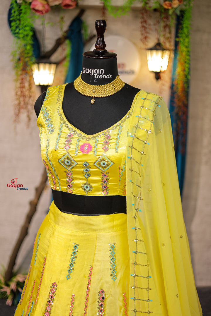 Yellow Japan Satin Silk lehenga with delicate mirror work and designer blouse perfect match for you