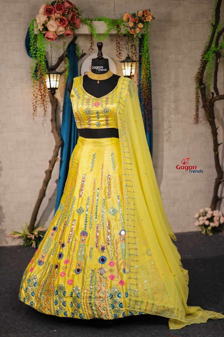 Yellow Japan Satin Silk lehenga with delicate mirror work and designer blouse perfect match for you
